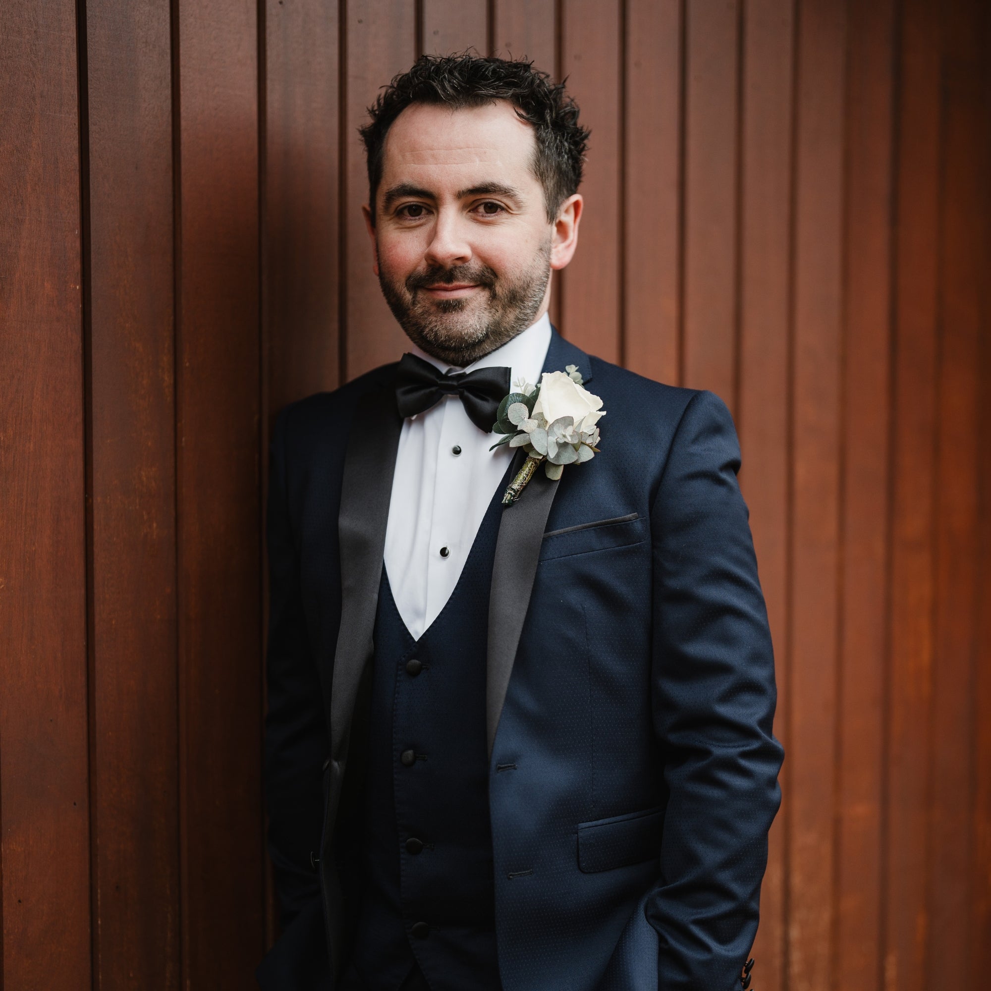 Groom wearing black silk bow tie by the belfast bow company